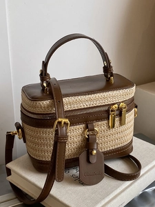 Straw box bag with brown leather trim, top handle, and crossbody strap for women