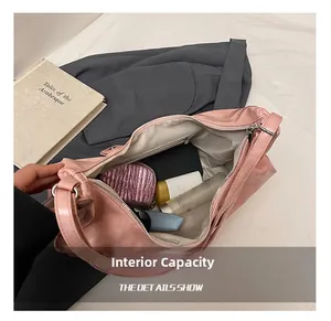 Spacious interior of pink leather tote bag showing cosmetics and organized pockets