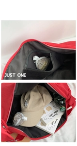 Macro view of red tote bag interior featuring a black lining and zip inner pocket