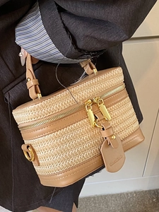Chic woven straw box handbag with brown faux leather trim and golden zipper detail