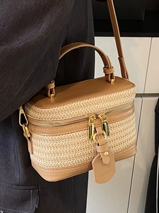 Minimalist straw vanity case bag with brown leather trim and adjustable crossbody strap