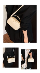 Detail of cream white oil wax leather handbag with dual zipper closure and top handle