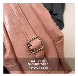 Detail of adjustable pink leather strap with silver square metal buckle on tote bag