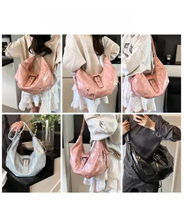 Detail showing vintage-style tote bag in pink, blue, and black with a large buckle strap