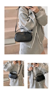 Detailed views of a black faux leather crossbody bag with gold hardware and logo