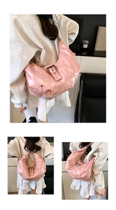 Detail of pink vintage faux leather tote showing metallic buckles and textured finish