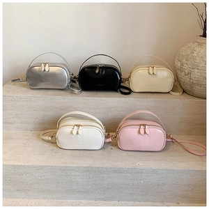 Detailed view of fashionable small square bags in five colors with double zippers