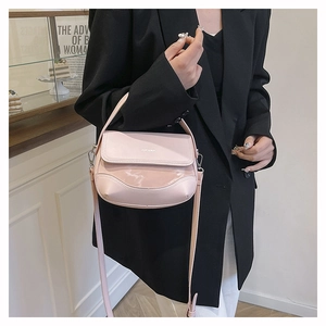Pale pink saddle bag detail showing refined texture and ZHCNMA logo on front flap