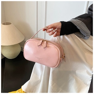 Detail view of pink oil wax leather handbag with double zipper and fashion logo