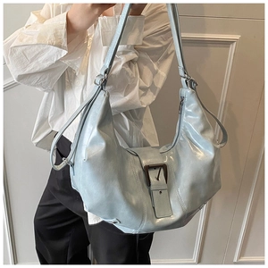 Macro shot of silver oversized hobo bag with vintage buckle and multi-strap details