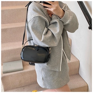 Chic black oil wax leather crossbody bag with adjustable strap and metal hardware