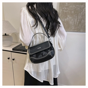 Detail of black saddle bag with white contrast stitching and ZHCNMA logo branding