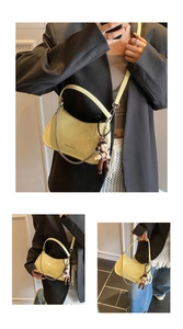 Macro view of bright yellow patent leather crescent bag with chic silver chain and charm