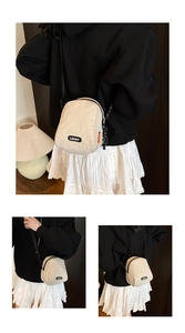 Detailed views of beige canvas crossbody bag with LUCKY label and black nylon strap