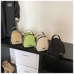 Close-up of stylish shell-shaped nylon bags in four colors with Lucky logo detail