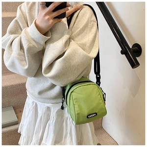 Green nylon crossbody bag with Lucky label and adjustable strap for casual daily use