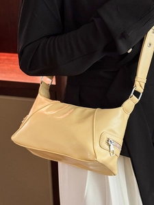 Minimalist creamy yellow tote bag in soft leather with side silver zipper detail
