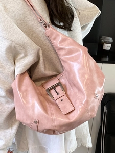 Pink glossy faux leather hobo bag with large silver metal buckle and rivets