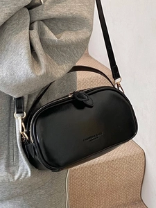 Fashionable black oil wax leather crossbody bag with gold hardware and dual zippers