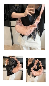 Détail du sac à bandoulière rose en croissant avec bretelles plissées et lacets stylés