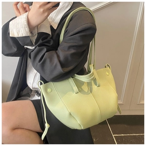 Detailed side view of light green lychee texture tote bag with stylish vertical stitching