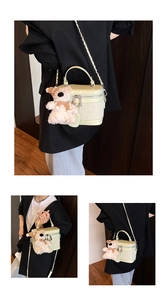 Detail view of light green quilted box bag with a cute bear plush charm and metal chain