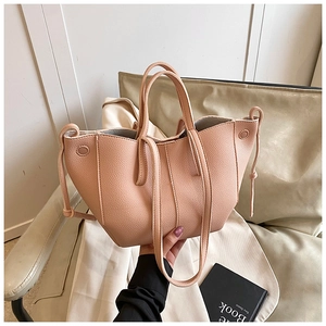Detail of light pink lychee pattern tote bag with side drawstring and slender straps