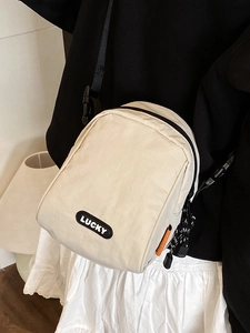 Versatile cream unisex crossbody bag with LUCKY logo and adjustable black shoulder strap