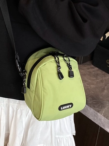 Bright green lightweight nylon mini crossbody bag with LUCKY patch and dual zippers