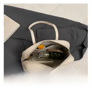 Top view of cream oil-waxed leather Boston bag showing large interior space and pockets