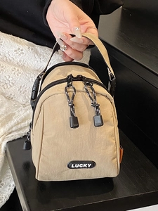 Beige nylon sports tote bag with LUCKY logo and zip closure for casual travel wear