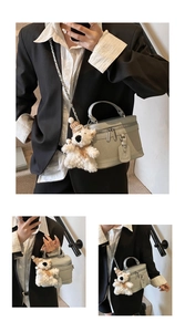 Detail of light green box bag featuring quilted pattern and cute plush bear charm