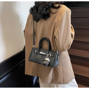 Elegant black lychee grain leather mini bag with silver lock and heart charm detail