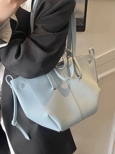 Minimalist light blue lychee pattern leather tote bag with wing shape and side tie details