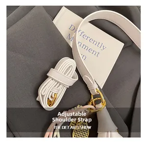 Detail of adjustable white oil wax leather strap with golden metal buckle and hooks