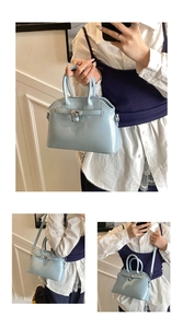 Close-up of light blue trapezoid shell bag featuring silver padlock and oil wax leather