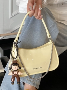 Fashionable yellow patent leather shoulder bag with silver chain and cute cartoon pendant