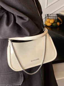 Chic patent leather shoulder bag in beige with silver chain and brand logo detail