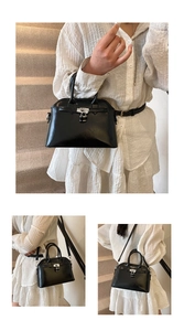 Detailed close-up showing the silver lock closure and oily leather texture of this handbag