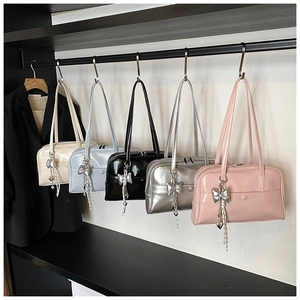 Detailed lineup of glossy shoulder bags in five colors with silver bow charms