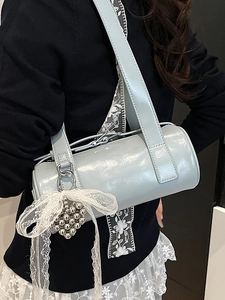 Light blue patent leather cylinder baguette bag with white lace bow and heart charm detail