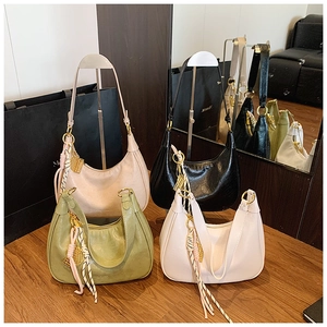 Detail of oil wax texture hobo bags in four colors with decorative pendants
