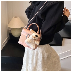 Pink box crossbody bag with woven texture and cute plush dog pendant on shoulder strap