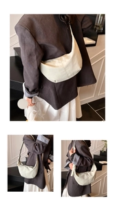 Detail of minimalist cream crescent hobo bag with adjustable wide strap and nylon texture