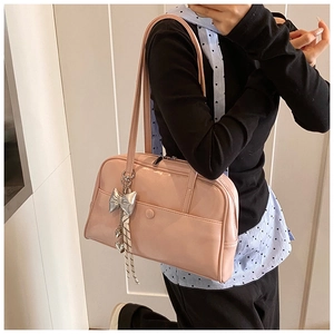 Pink faux leather Boston bag shoulder strap and silver butterfly heart charms detail