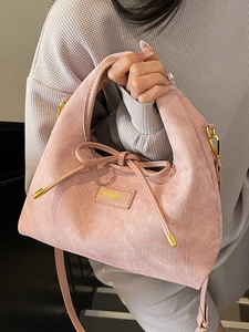 Pink corduroy handbag for women with bow detail and brand logo in a casual style