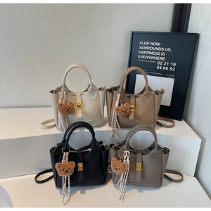 Litchi pattern bucket bags in multiple colors with cute teddy bear charms and gold hardware