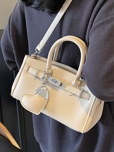 Beige lychee texture leather handbag with heart pendant and silver lock for women
