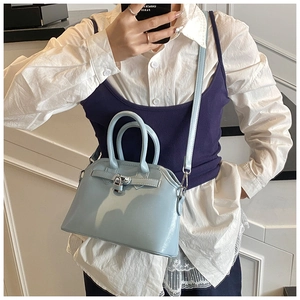 Detailed view of serenity blue shell bag with silver buckle and leather straps