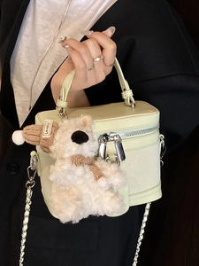 Elegant light mint green box handbag with chain strap and cute plush bear charm